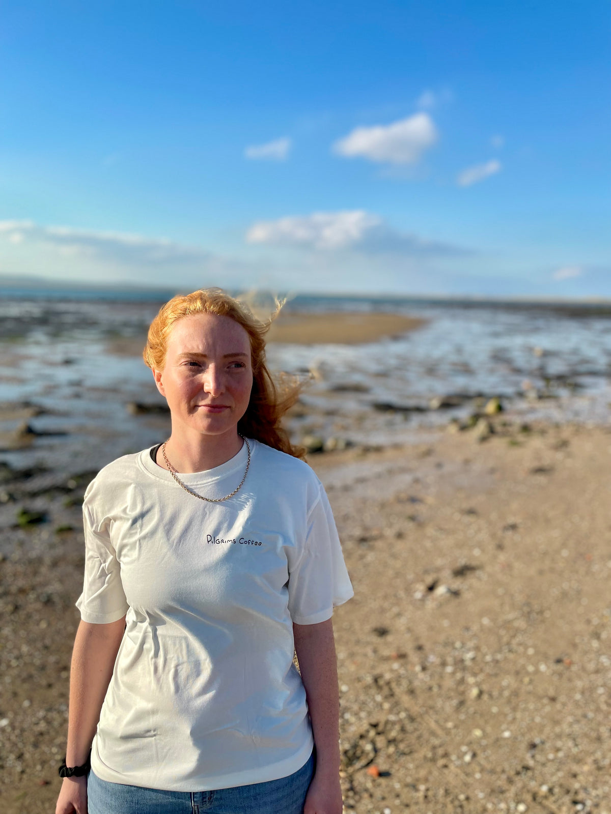 Kate wearing the Pilgrims Coffee organic cotton t-shirt on the beach