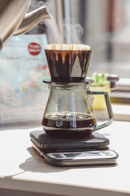 Pour over brewing with the Timemore Crystal Eye dripper on a scale