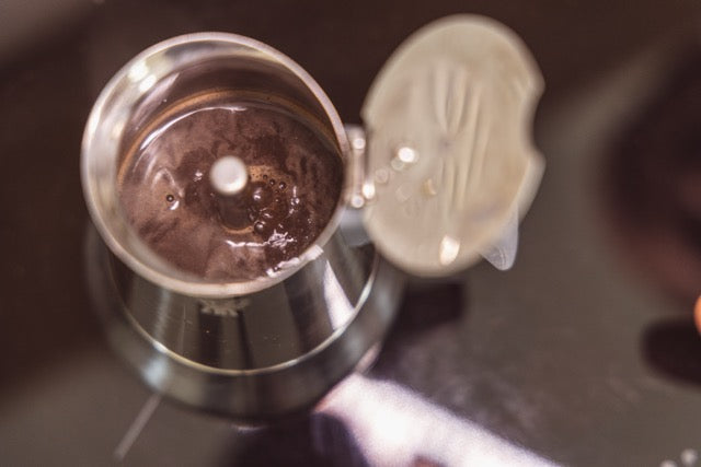 Moka pot open, showing coffee brewed inside